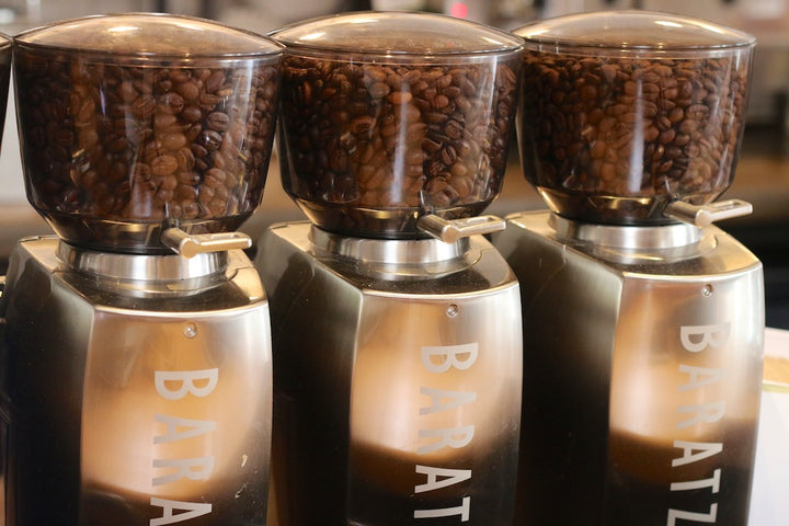 Three burr grinders with whole bean coffee