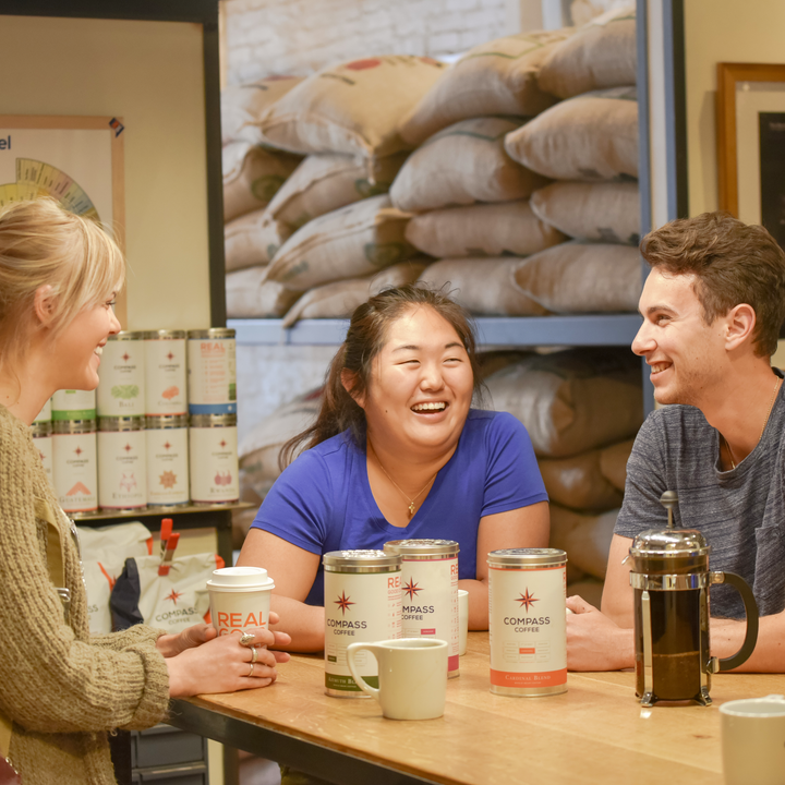 Friends enjoying a french press of Compass Coffee